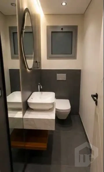 Elegant Guest Bathroom with Backlit Oval Mirror and Grey Finishes