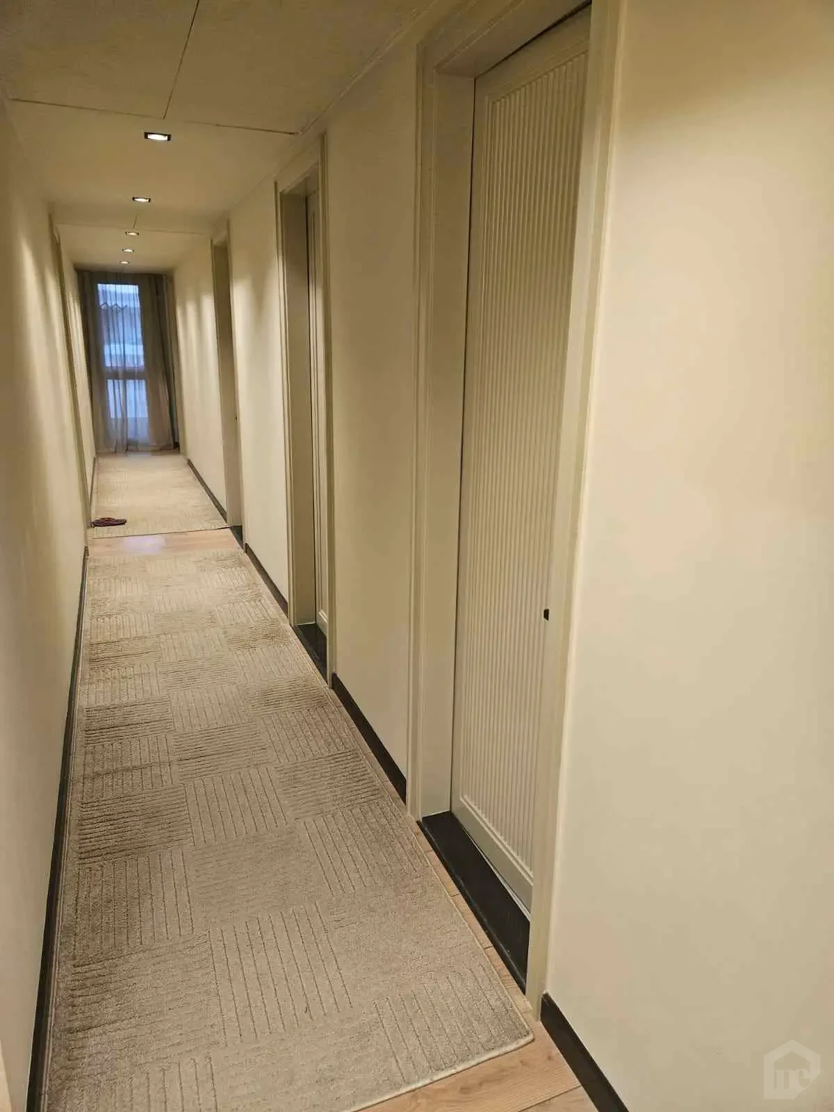 Quiet Interior Hallway with Wooden Flooring and Long Curtains