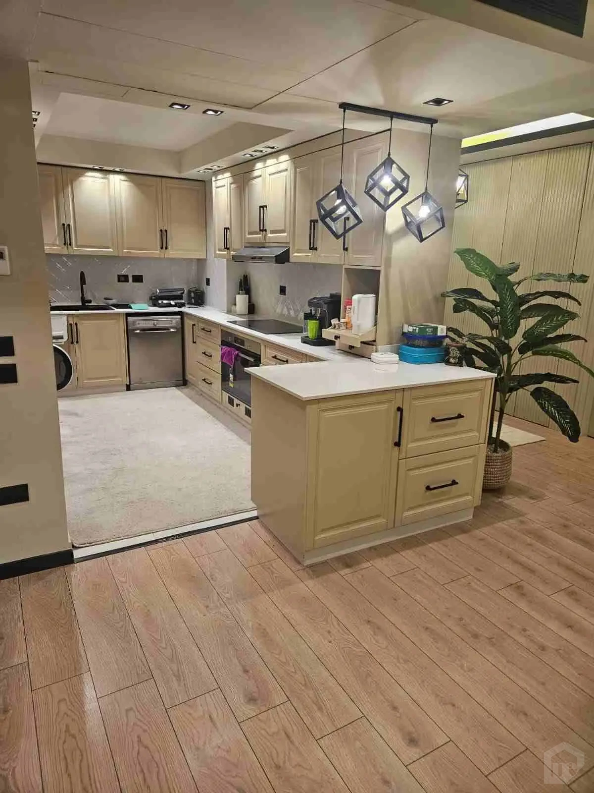 Another View of the Modern Kitchen with Central Island and Distinct Lightin