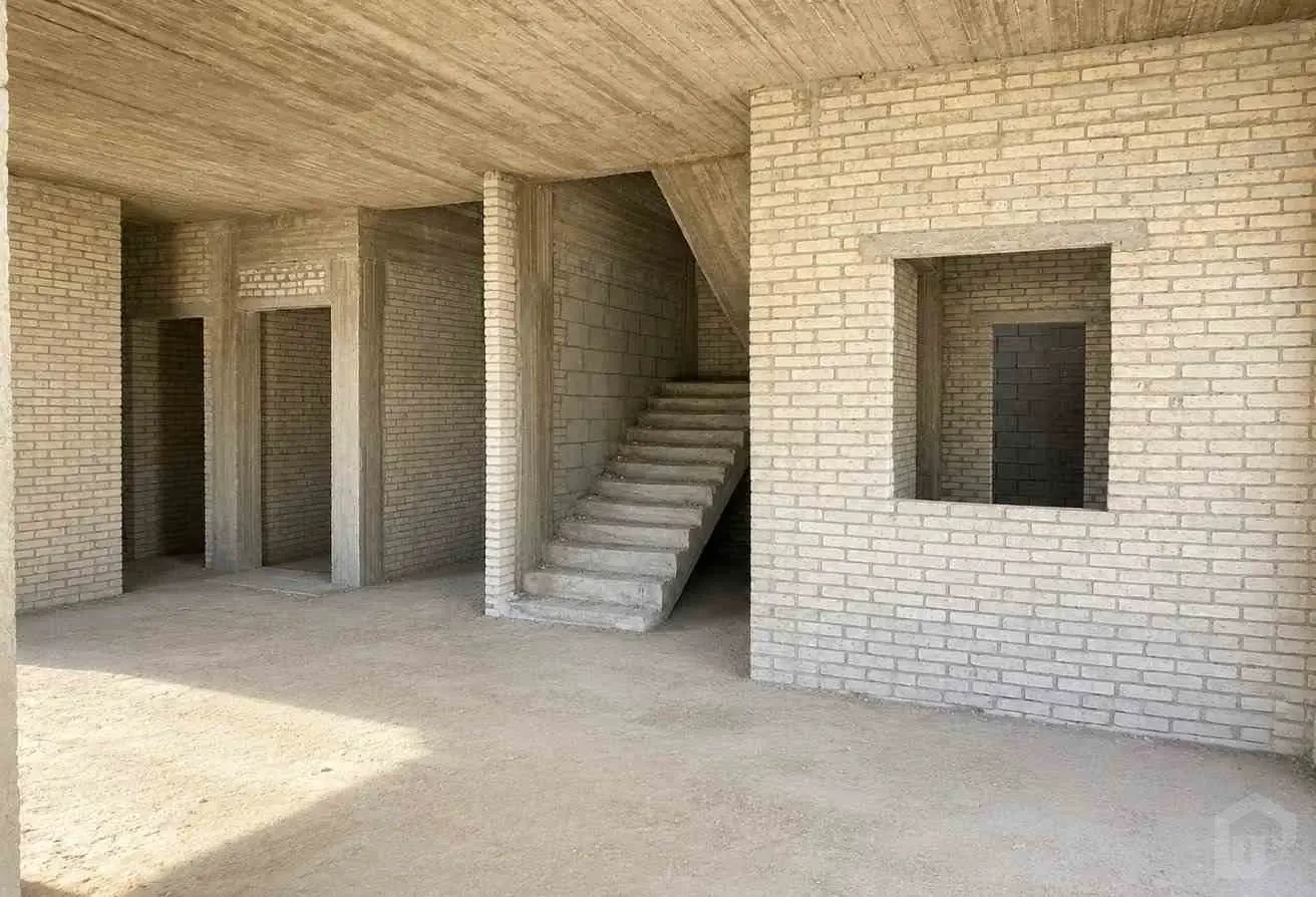 Interior Shot of a Residential Unit Under Construction (Brick and Concrete Stage) with Large Window Openings